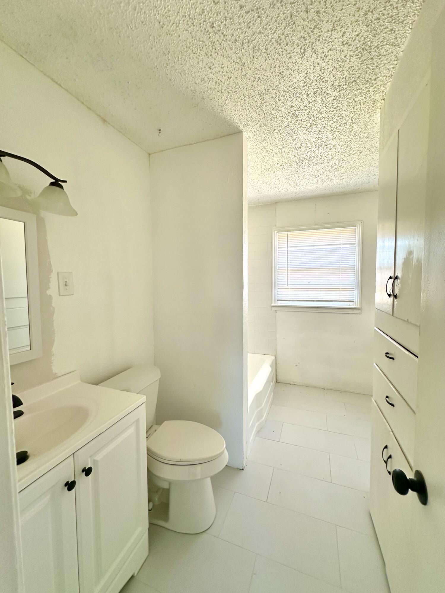 1827 8th Street Levelland, TX 79336 - Photo 16 of 25 a bathroom with a sink a toilet and shower