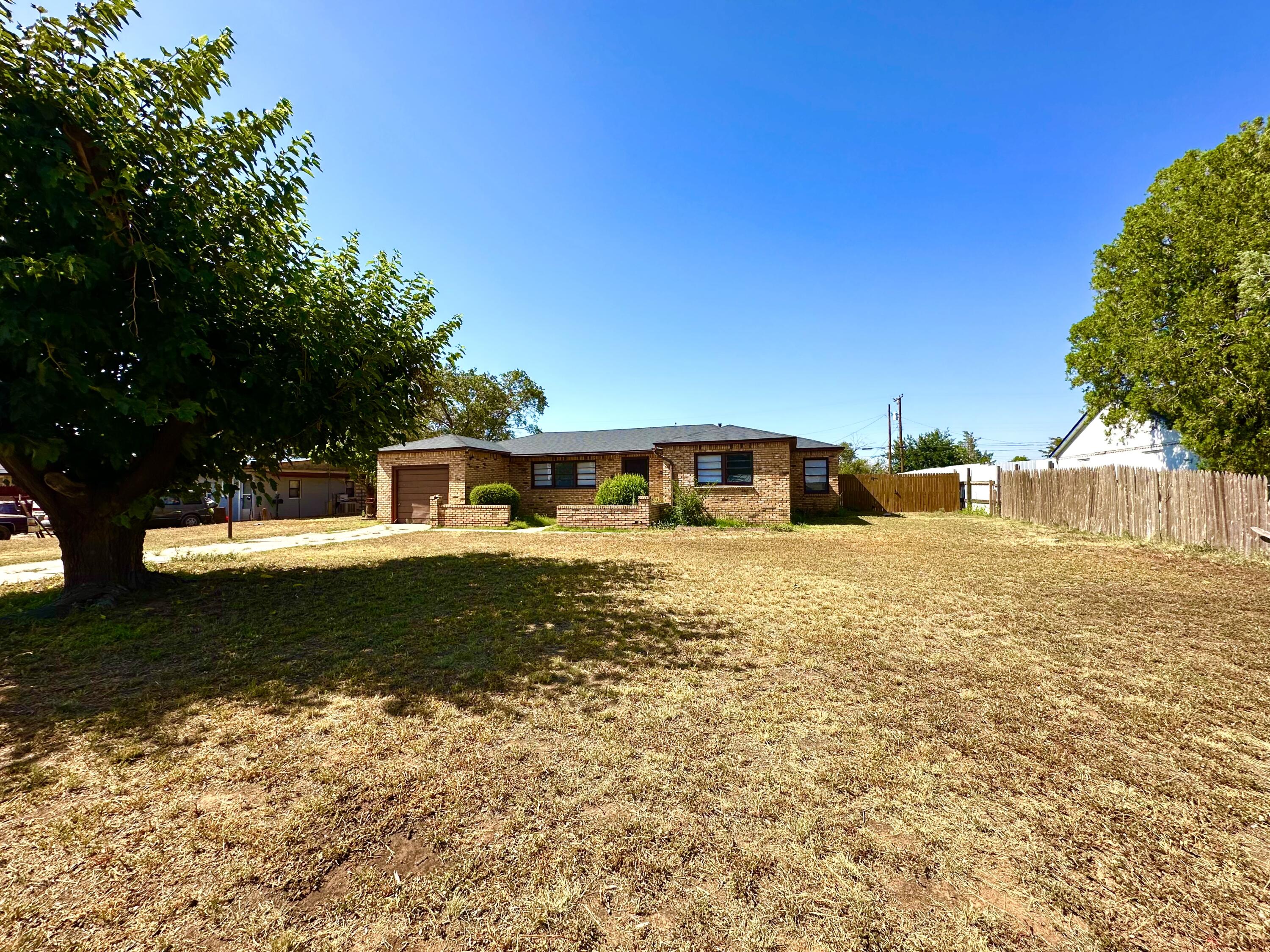1827 8th Street Levelland, TX 79336 - Photo 2 of 25 a front view of a house with a yard
