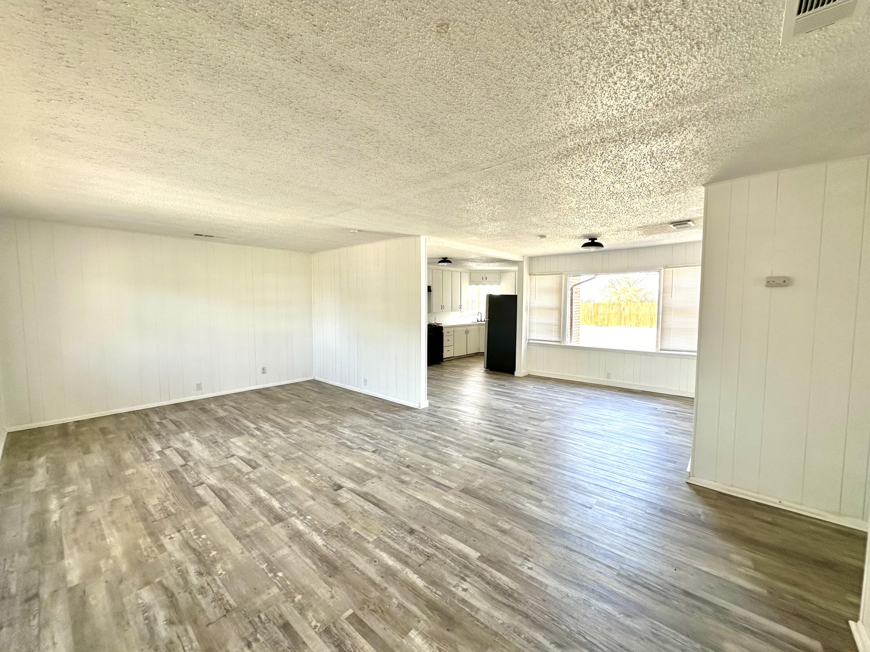 1827 8th Street Levelland, TX 79336 - Photo 5 of 25 a view of empty room with wooden floor and fan