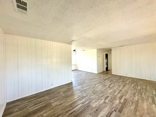 a view of an empty room and wooden floor