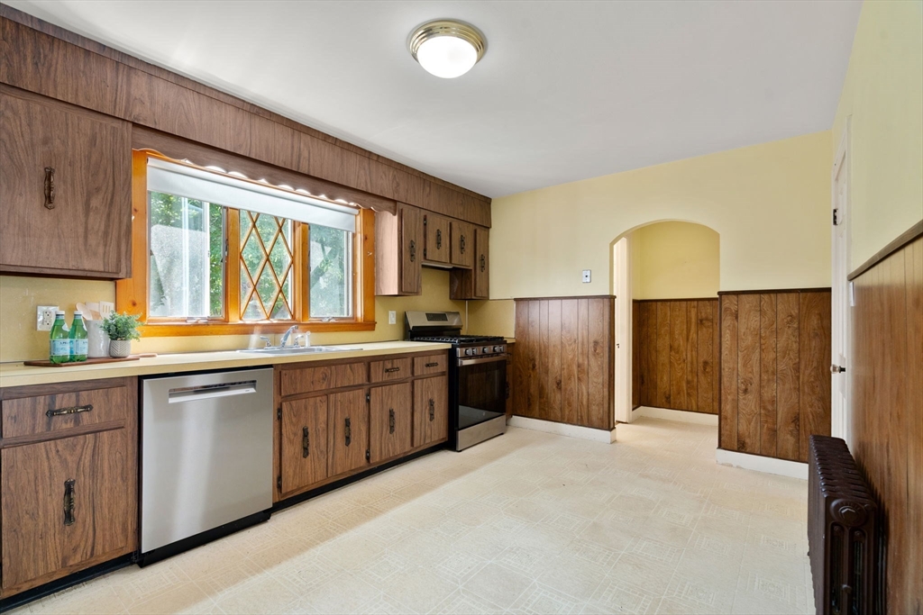 14 Rendall Road Boston, MA 02132 - Photo 6 of 21 a large kitchen with a large window and stainless steel appliances