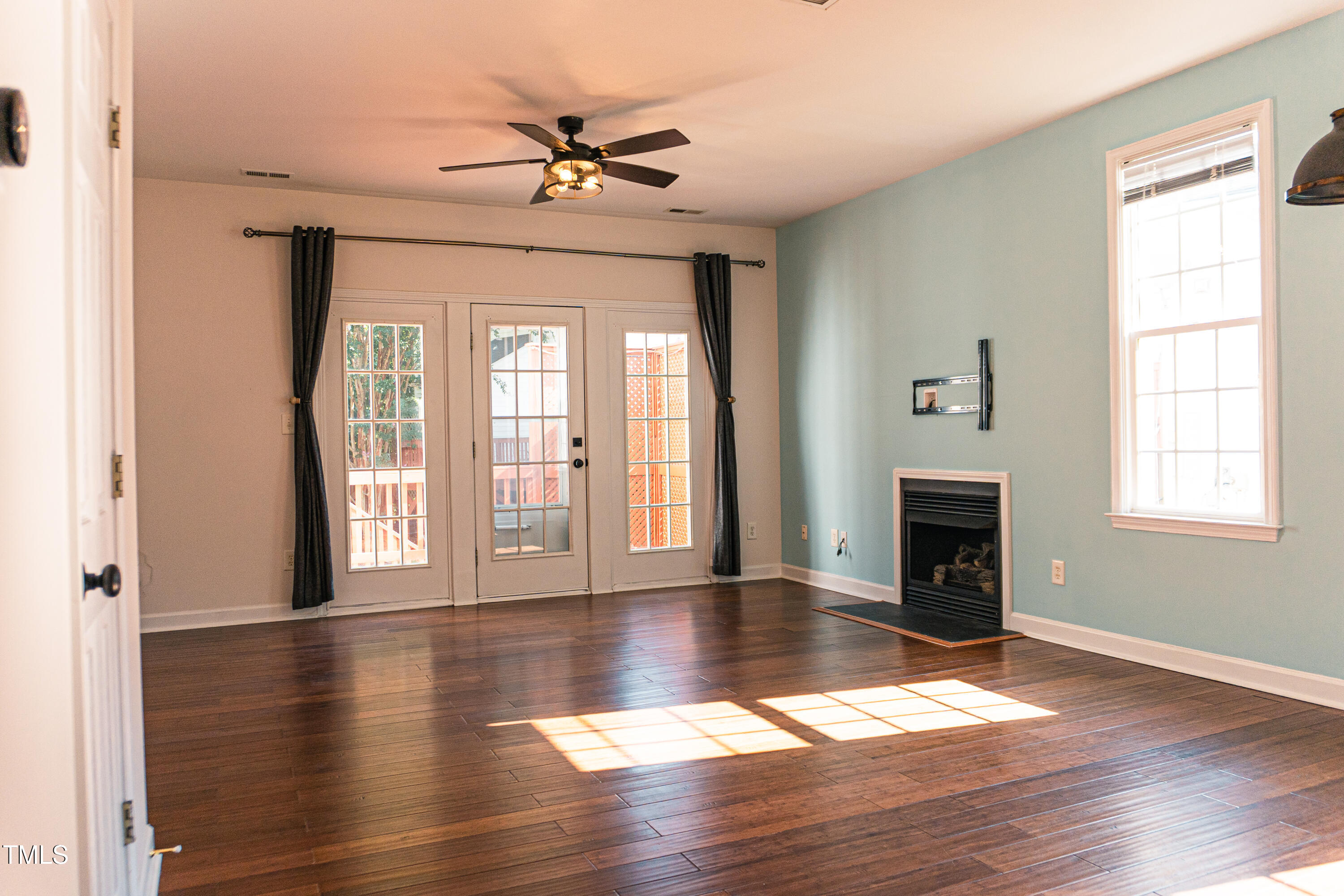 2271 Trailwood Valley Circle Raleigh, NC 27603 - Photo 11 of 36 a view of an empty room with wooden floor and a window