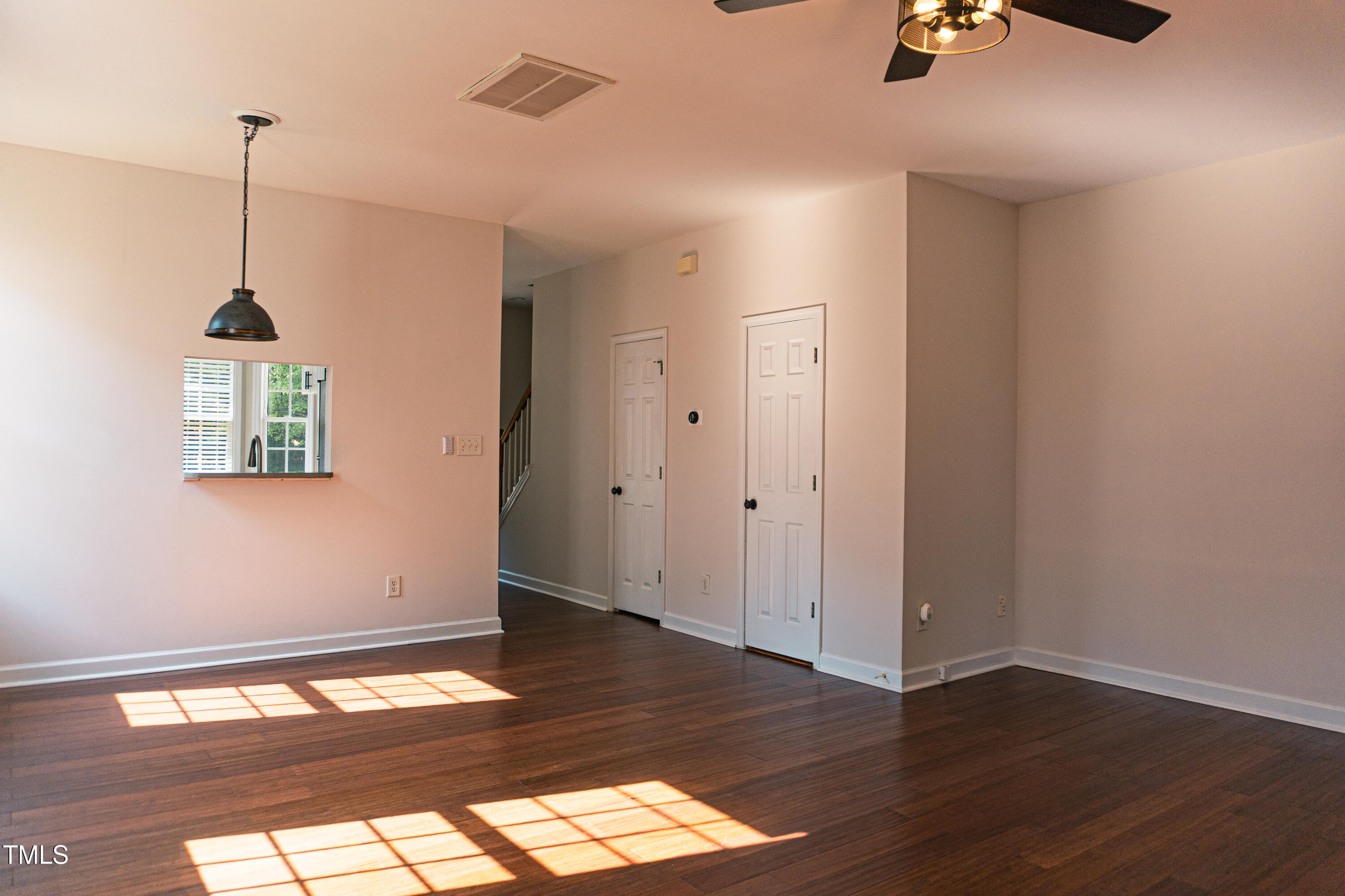 2271 Trailwood Valley Circle Raleigh, NC 27603 - Photo 14 of 36 a view of an empty room with wooden floor and a window
