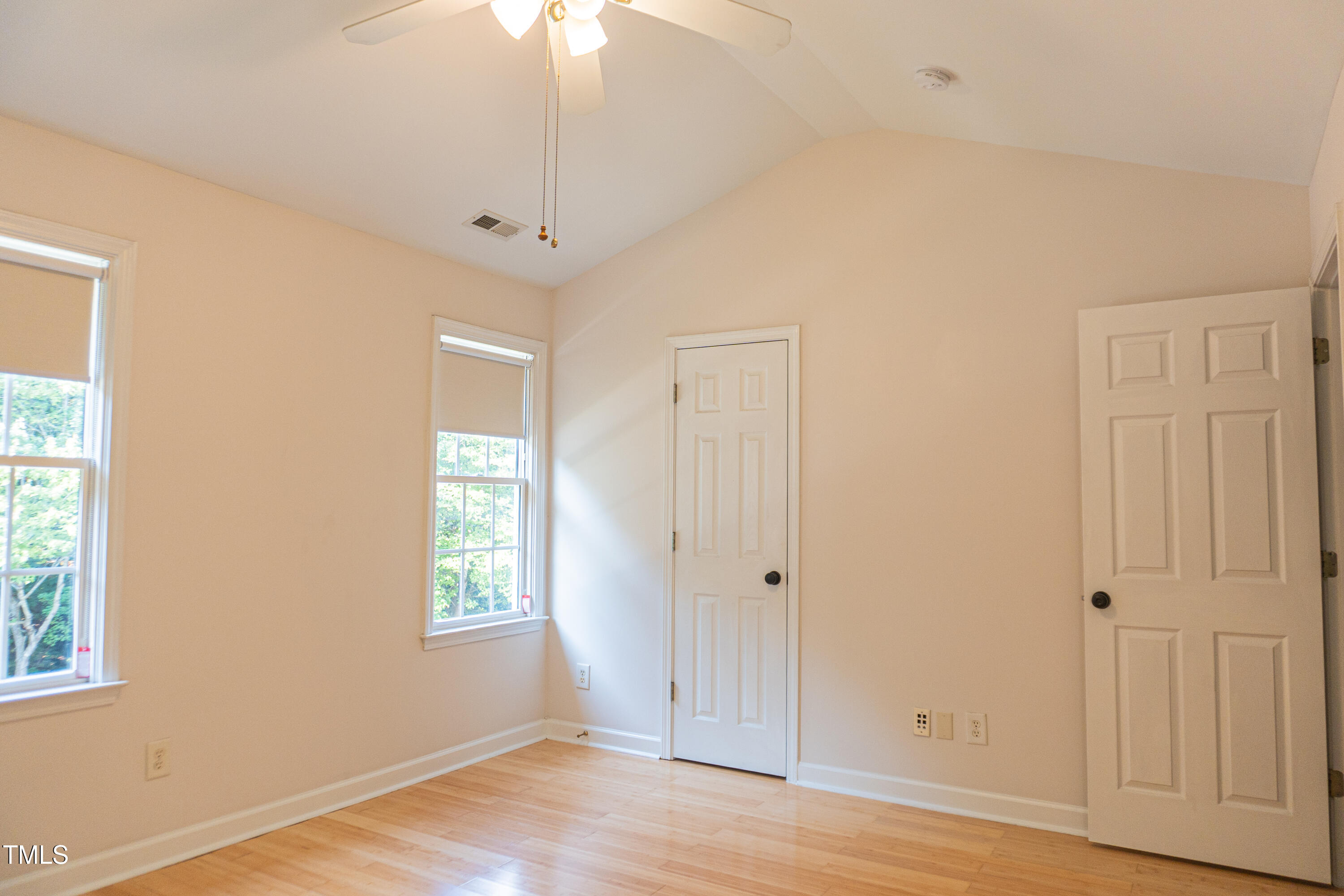 2271 Trailwood Valley Circle Raleigh, NC 27603 - Photo 21 of 36 an empty room with wooden floor cabinet and windows