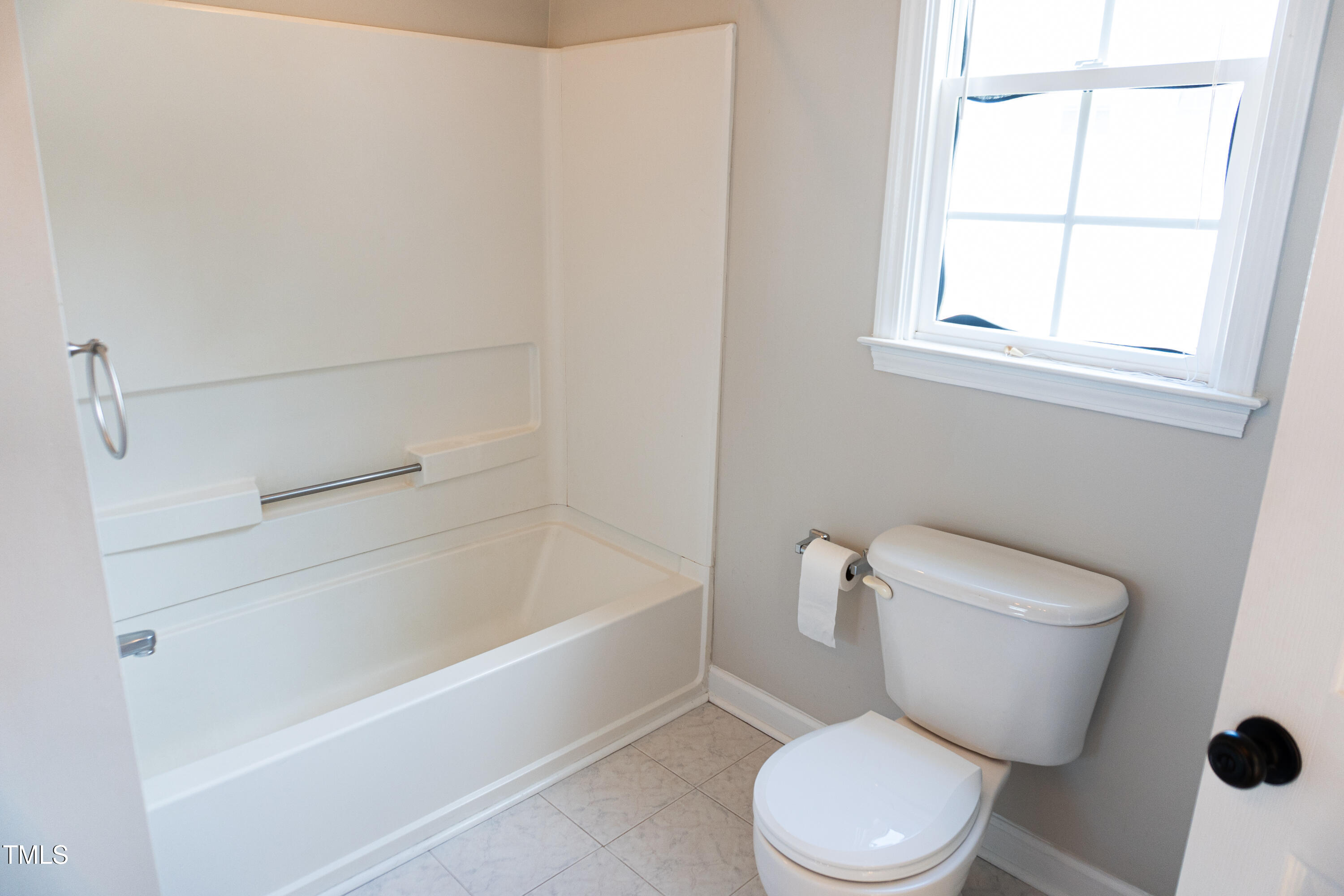 2271 Trailwood Valley Circle Raleigh, NC 27603 - Photo 26 of 36 a white toilet sitting next to a bath tub