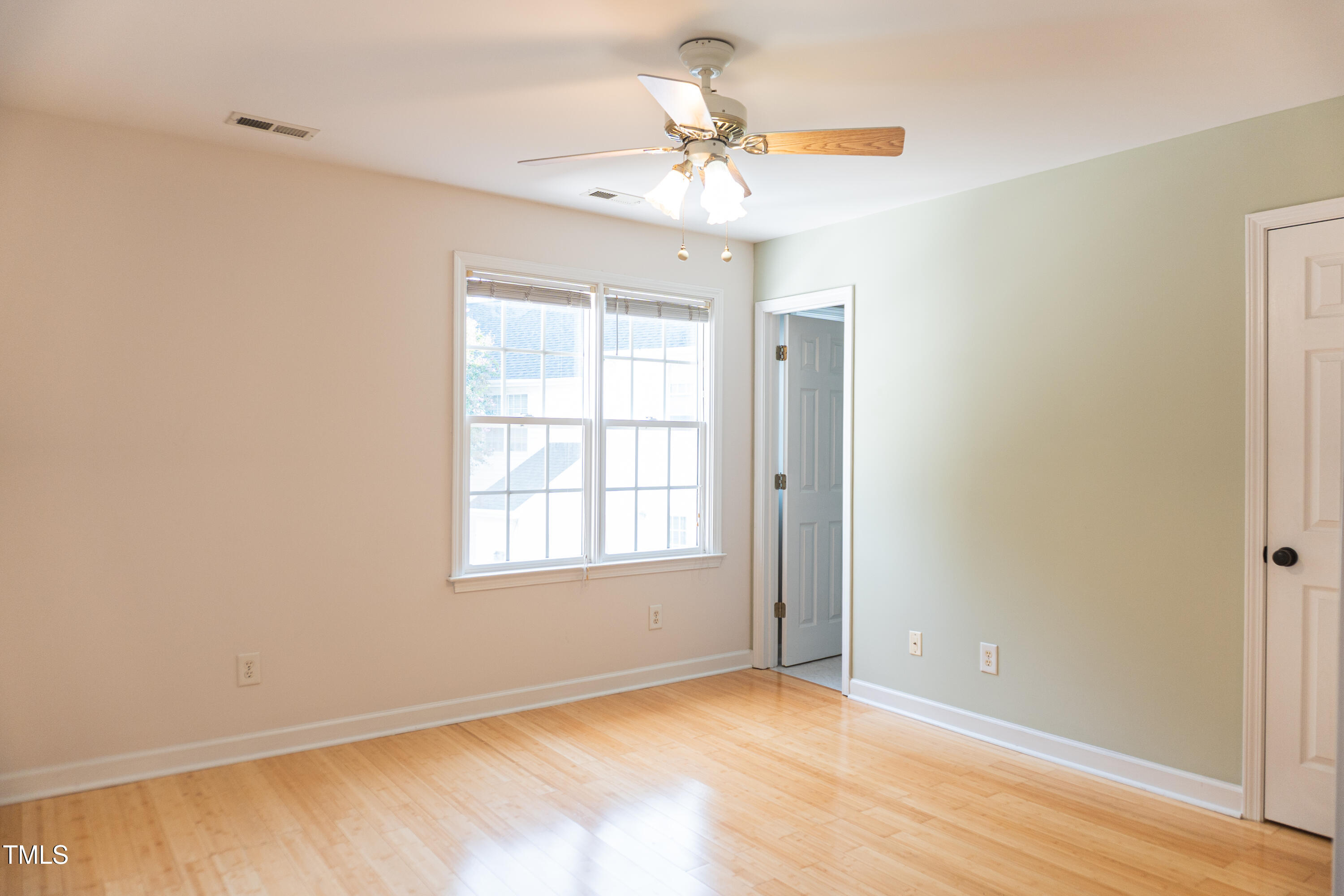 2271 Trailwood Valley Circle Raleigh, NC 27603 - Photo 28 of 36 an empty room with chandelier fan and windows