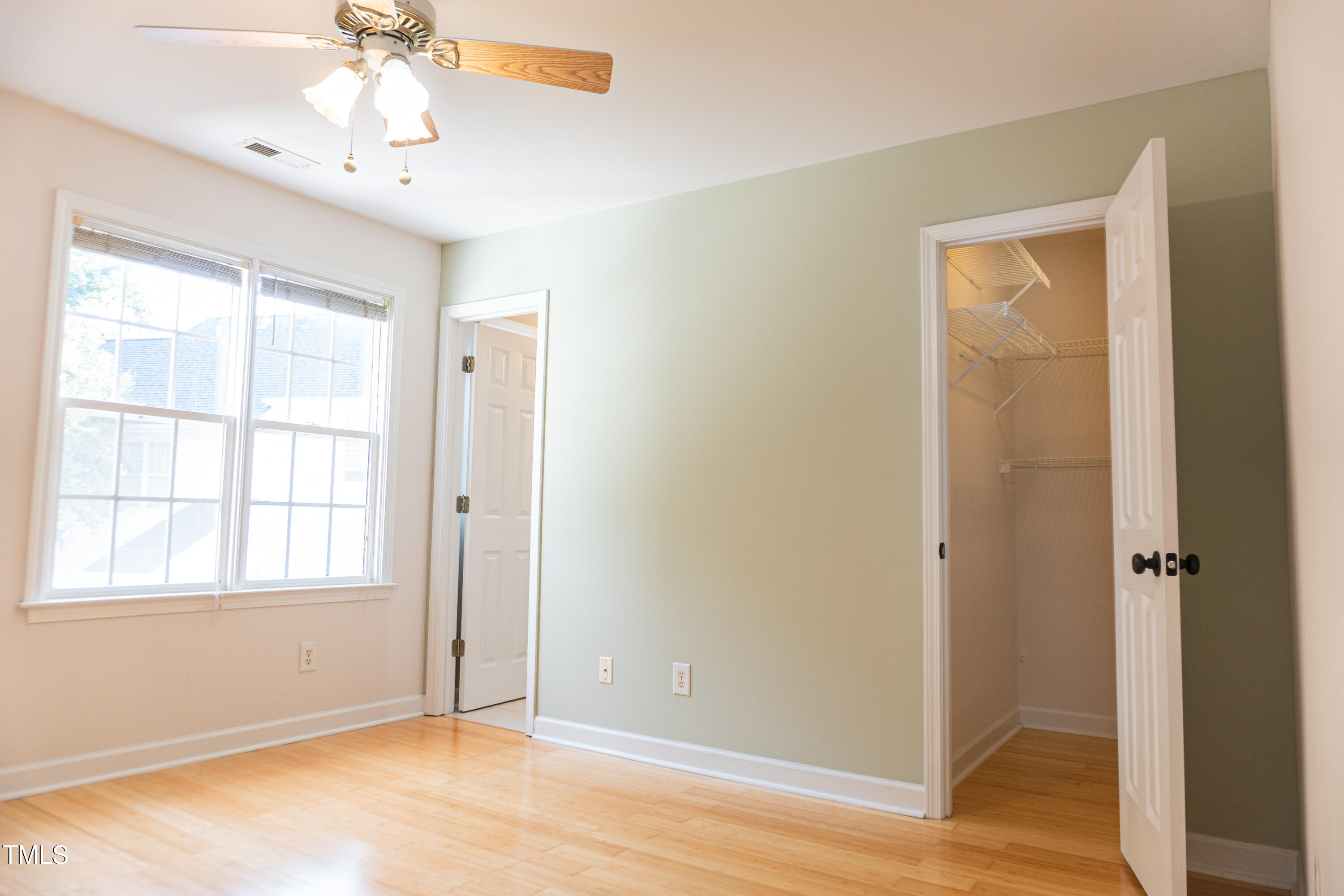 2271 Trailwood Valley Circle Raleigh, NC 27603 - Photo 29 of 36 a view of an empty room with wooden floor and a window