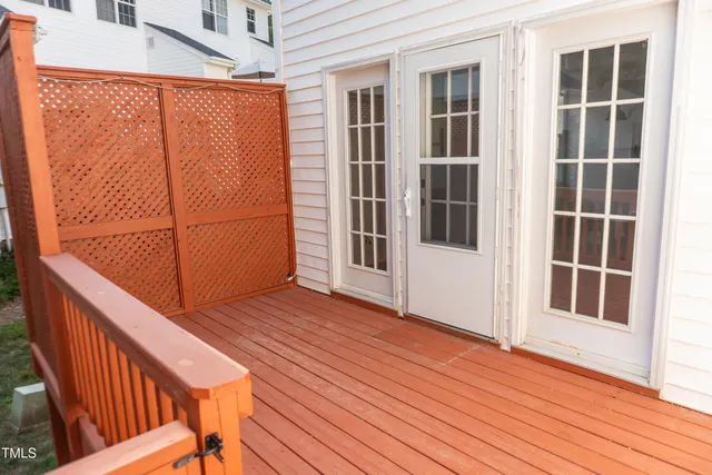 a view of balcony with wooden floor and fence