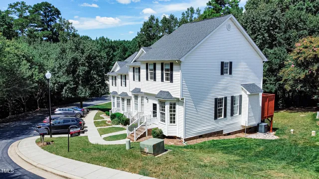 a aerial view of a house with a yard table and chairs
