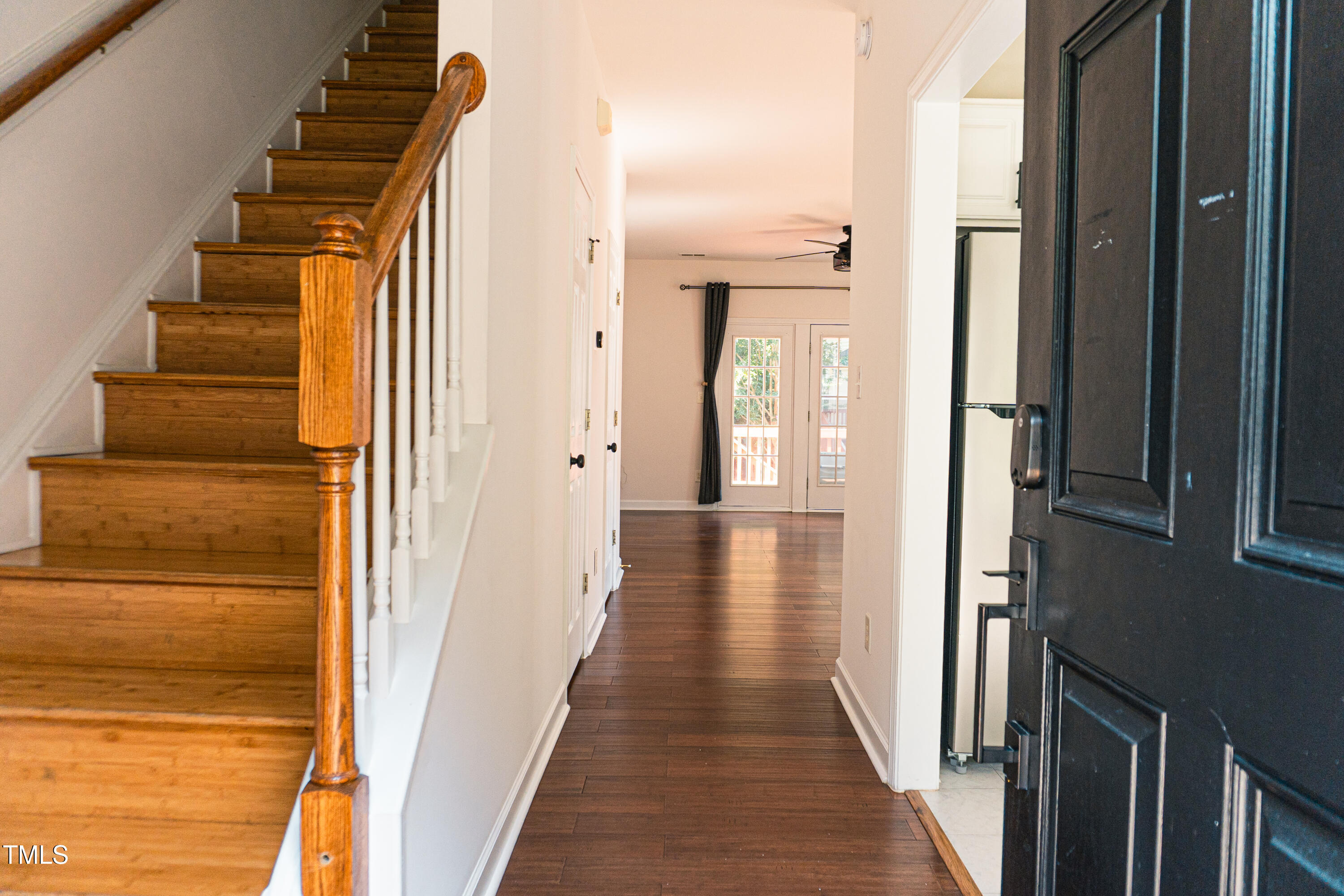 2271 Trailwood Valley Circle Raleigh, NC 27603 - Photo 4 of 36 a view of a hallway with wooden floor and staircase
