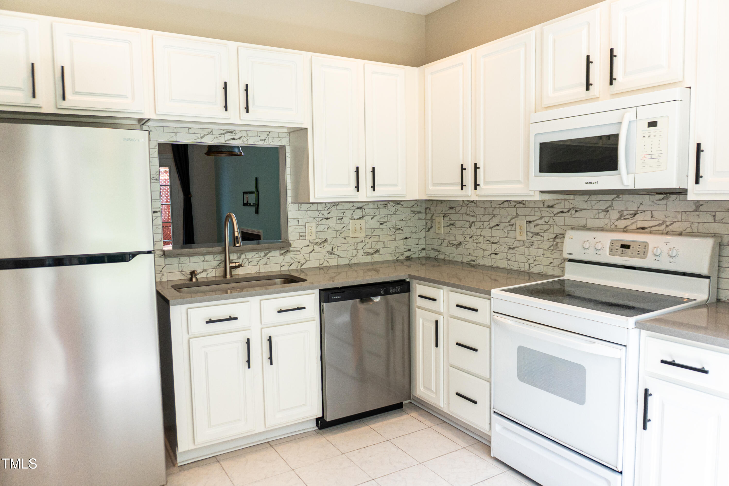 2271 Trailwood Valley Circle Raleigh, NC 27603 - Photo 6 of 36 a kitchen with white cabinets and white appliances