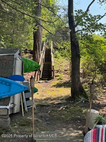 a view of a backyard with table and chairs with wooden floor and fence