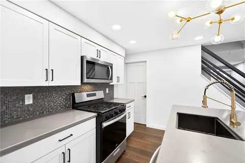 a kitchen with a refrigerator stove and microwave