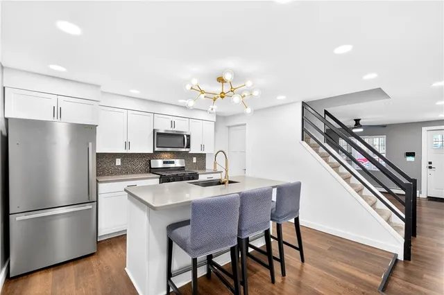 a kitchen that has a table and chairs in it