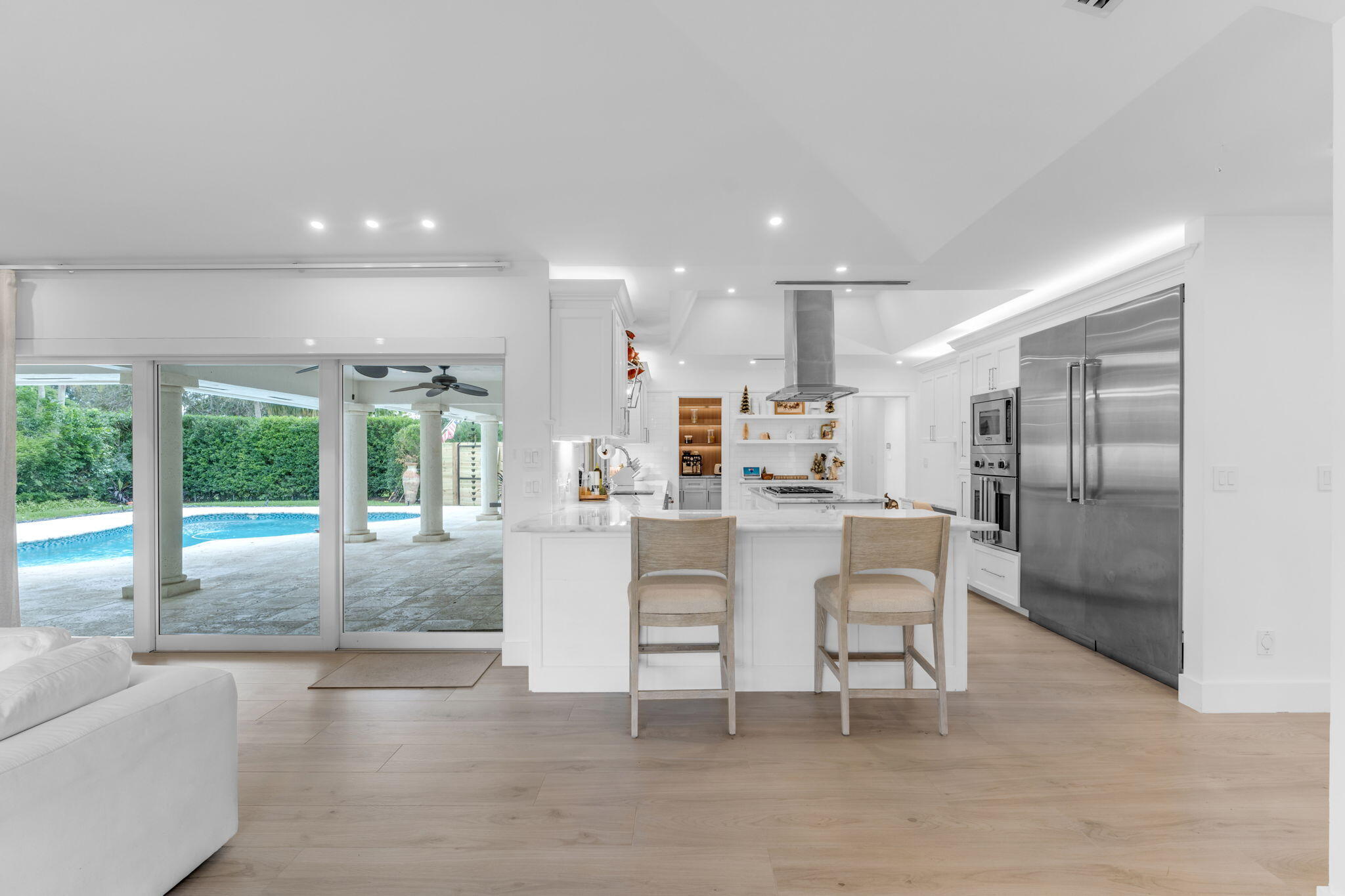 16941 Southwest 278th Street Homestead, FL 33031 - Photo 12 of 44 a dining area with stainless steel appliances kitchen island granite countertop a refrigerator a sink a dining table and chairs with wooden floor