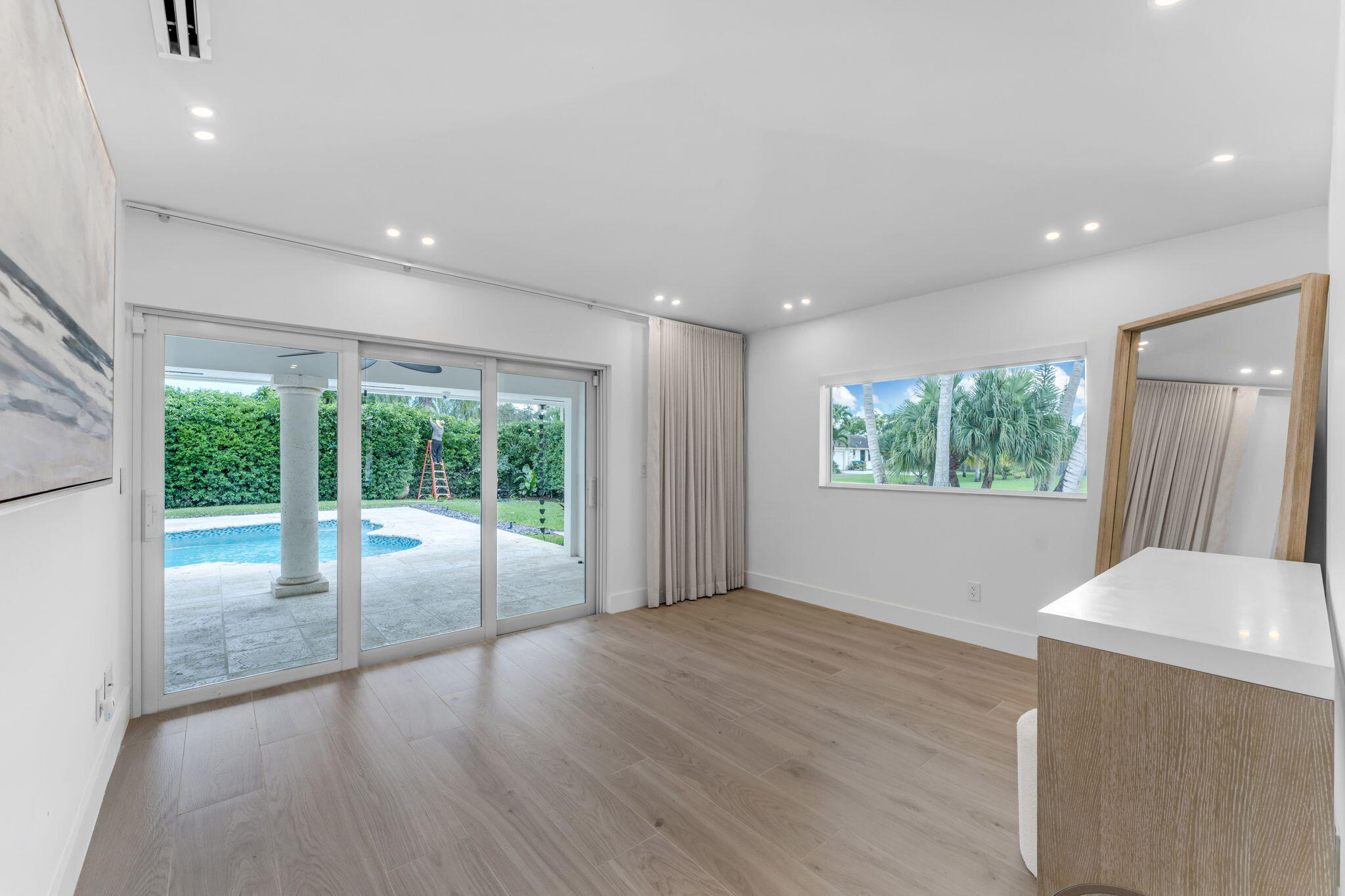 16941 Southwest 278th Street Homestead, FL 33031 - Photo 16 of 44 a view of an empty room with wooden floor and a window