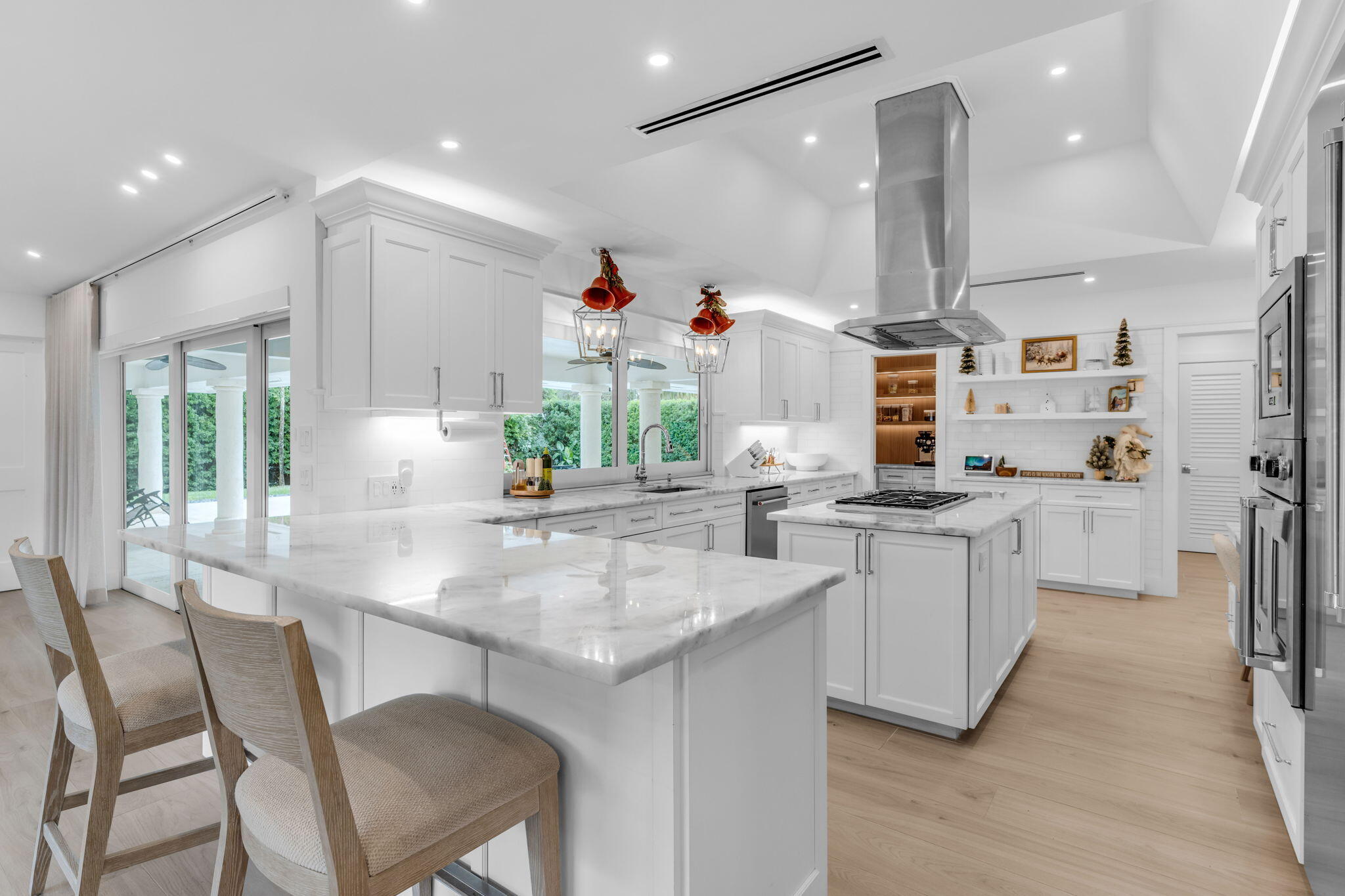 16941 Southwest 278th Street Homestead, FL 33031 - Photo 23 of 44 a kitchen with stainless steel appliances kitchen island granite countertop a table chairs and a refrigerator