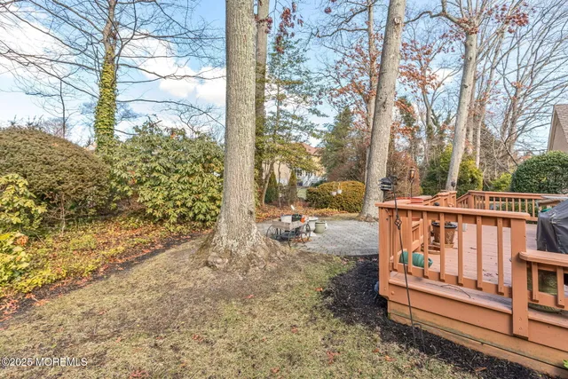 a view of a patio with couches table and chairs and wooden floor