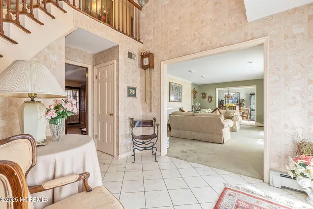 a living room with furniture and a potted plant