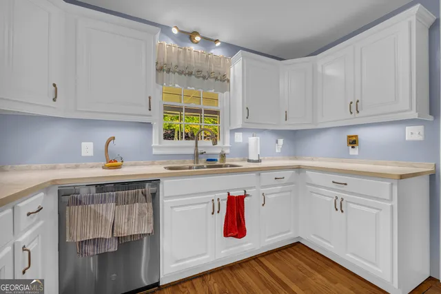 a view of a kitchen with wooden floor and staircase