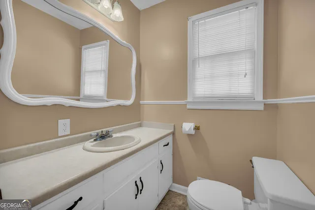 an empty room with closet and a chandelier fan