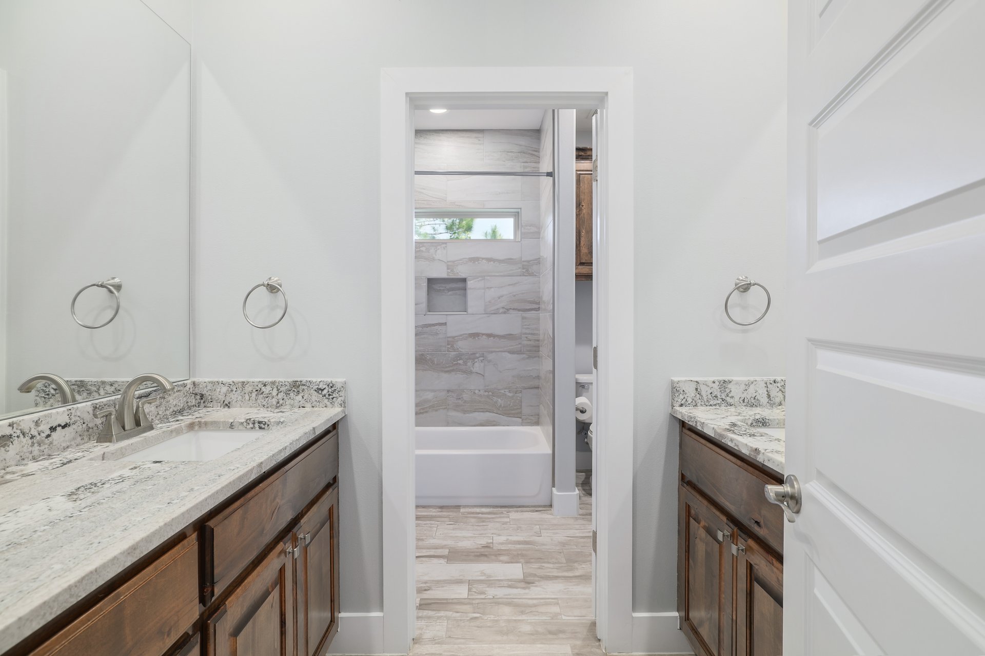 258 County Road Bastrop, TX 78602 - Photo 18 of 32 a bathroom with a granite countertop sink a mirror and a shower