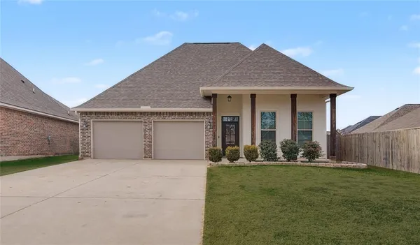 a front view of house with yard and green space