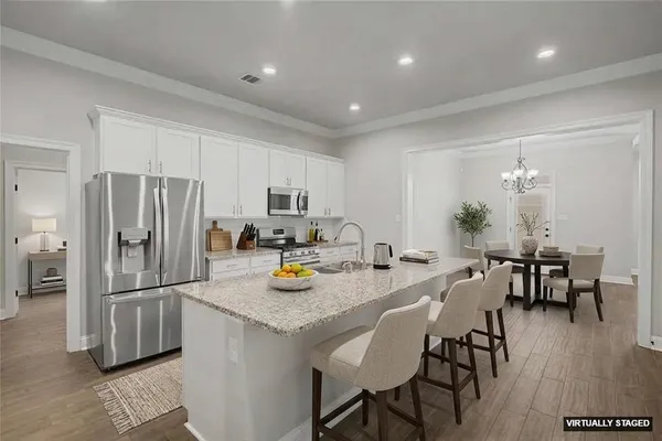 a kitchen with refrigerator and dining table
