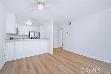 a view of kitchen with wooden floor and window