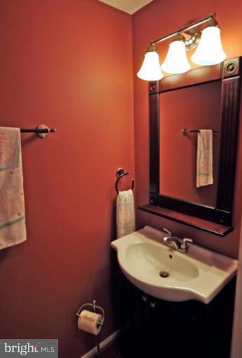 10902 Harpers Square Court Reston, VA 20191 - Photo 19 of 19 a bathroom with a sink and a mirror