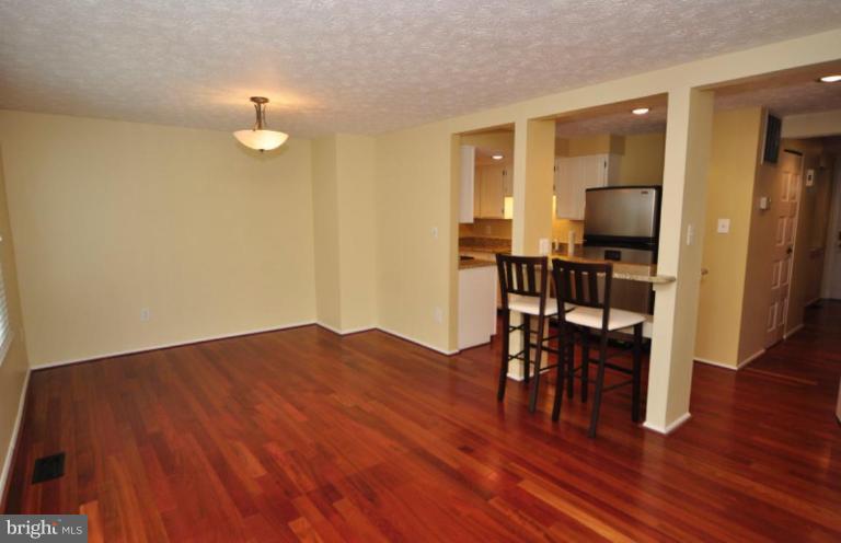 10902 Harpers Square Court Reston, VA 20191 - Photo 4 of 19 a view of a dining room with furniture and wooden floor