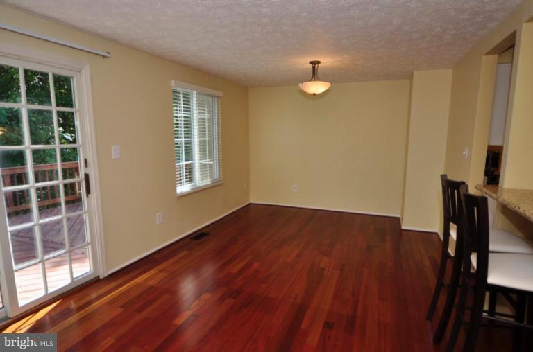 10902 Harpers Square Court Reston, VA 20191 - Photo 5 of 19 a view of an empty room with wooden floor and a window