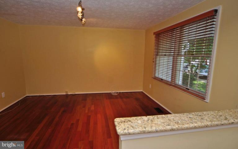 10902 Harpers Square Court Reston, VA 20191 - Photo 7 of 19 a view of wooden floor and brick walls