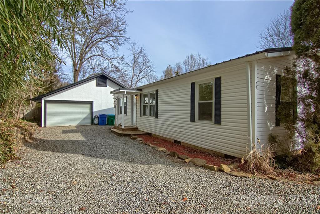 a view of a house with a yard and garage
