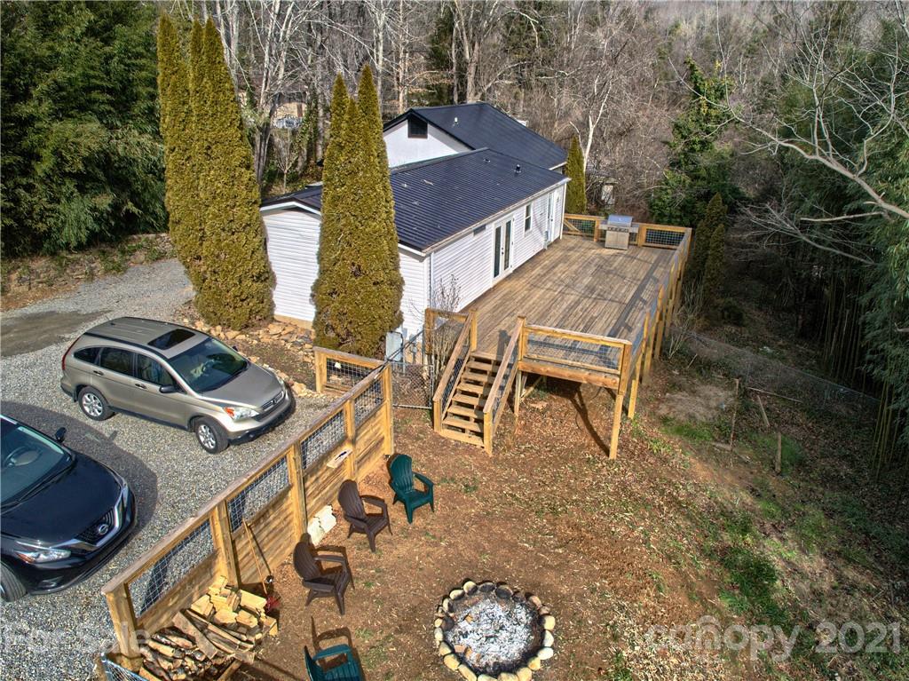 73 Church Road Fairview, NC 28730 - Photo 2 of 45 a view of a patio with table and chairs with wooden floor