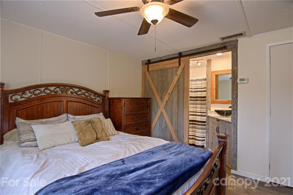 73 Church Road Fairview, NC 28730 - Photo 16 of 45 a bedroom with a bed and a dresser
