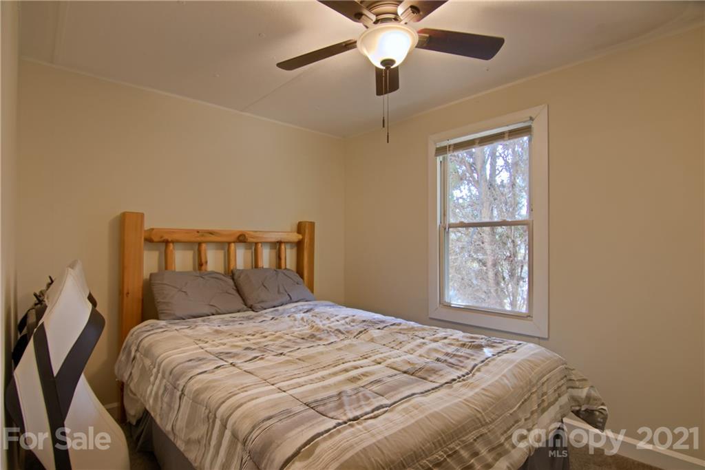 73 Church Road Fairview, NC 28730 - Photo 20 of 45 a bedroom with a bed and a window