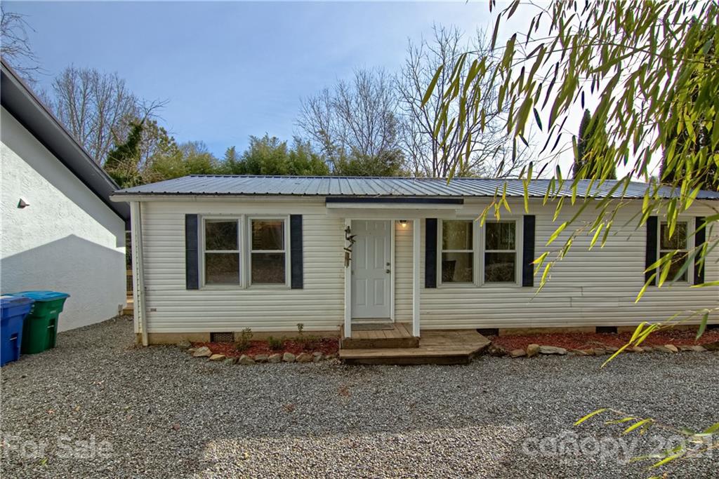 73 Church Road Fairview, NC 28730 - Photo 3 of 45 a front view of a house with garden
