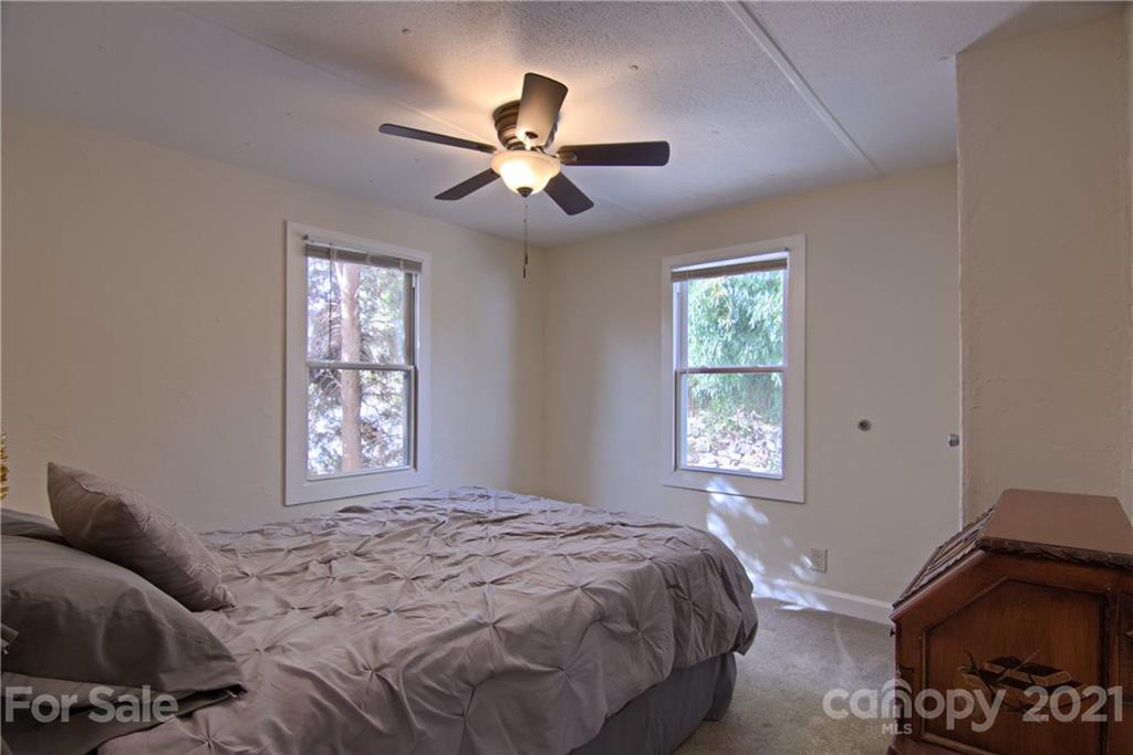 73 Church Road Fairview, NC 28730 - Photo 21 of 45 a bedroom with a bed and a window