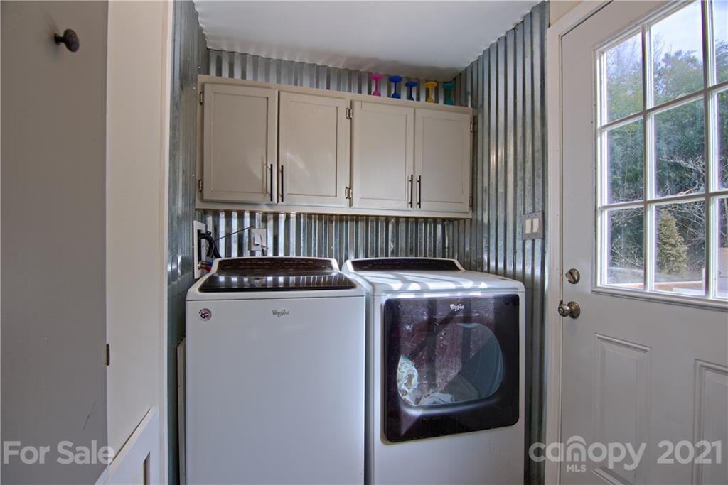 73 Church Road Fairview, NC 28730 - Photo 22 of 45 a view of washer and dryer with kitchen in the background