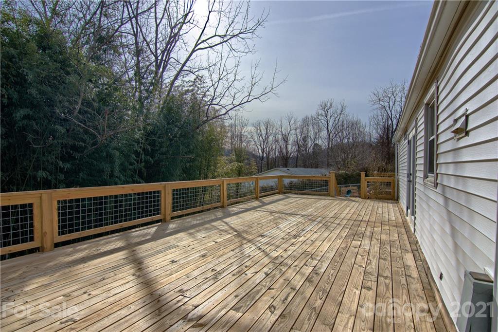 73 Church Road Fairview, NC 28730 - Photo 23 of 45 a view of balcony with wooden floor and fence and trees