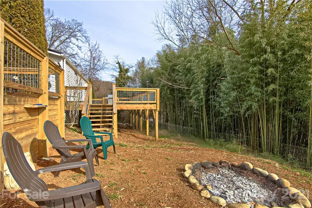 73 Church Road Fairview, NC 28730 - Photo 25 of 45 a backyard of a house with barbeque oven table and chairs