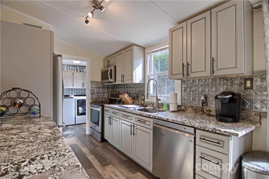 73 Church Road Fairview, NC 28730 - Photo 4 of 45 a kitchen with a sink stove and refrigerator