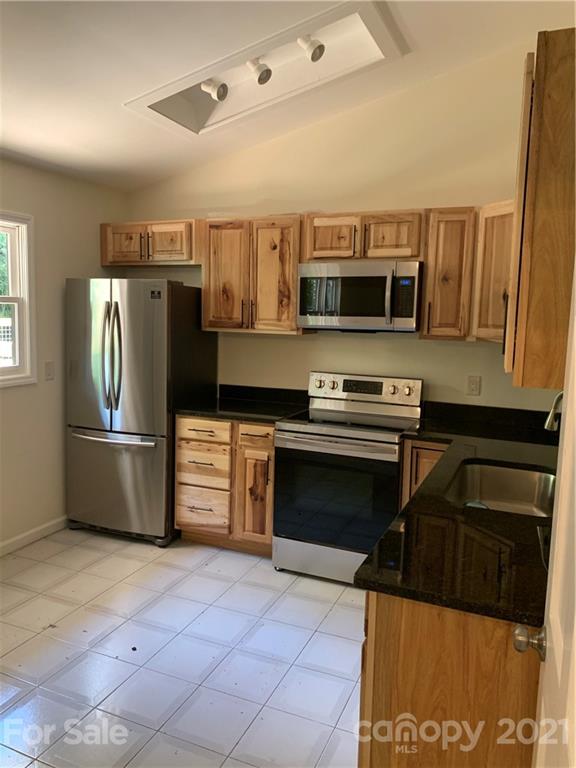 73 Church Road Fairview, NC 28730 - Photo 37 of 45 a kitchen with stainless steel appliances a stove a microwave and a refrigerator