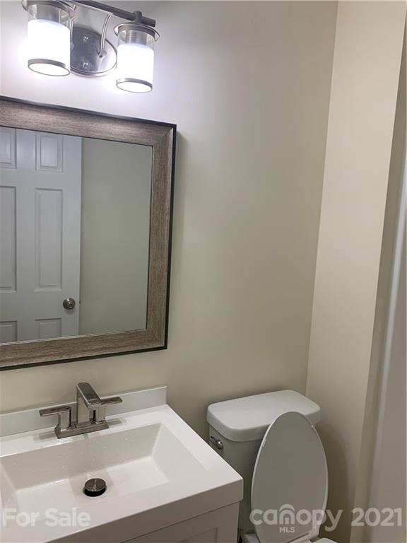 73 Church Road Fairview, NC 28730 - Photo 42 of 45 a bathroom with a toilet a sink and mirror