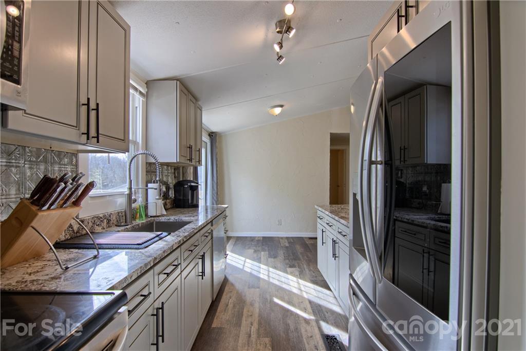 73 Church Road Fairview, NC 28730 - Photo 6 of 45 a kitchen with stainless steel appliances granite countertop a refrigerator and a sink