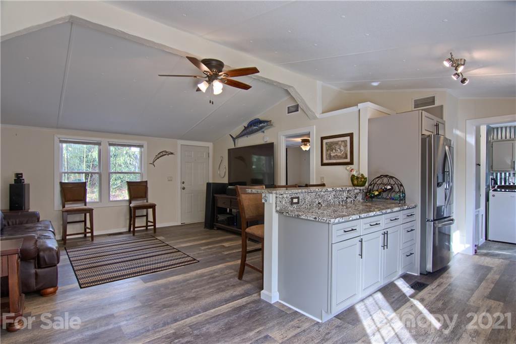 73 Church Road Fairview, NC 28730 - Photo 8 of 45 a living room with stainless steel appliances kitchen island furniture and a flat screen tv