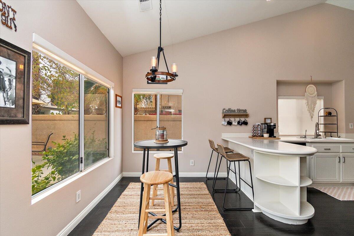 45510 Desert Fox Drive La Quinta, CA 92253 - Photo 19 of 49 a view of a dining room with furniture large windows and wooden floor