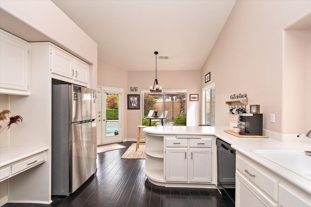 45510 Desert Fox Drive La Quinta, CA 92253 - Photo 23 of 49 a kitchen with white cabinets and stainless steel appliances