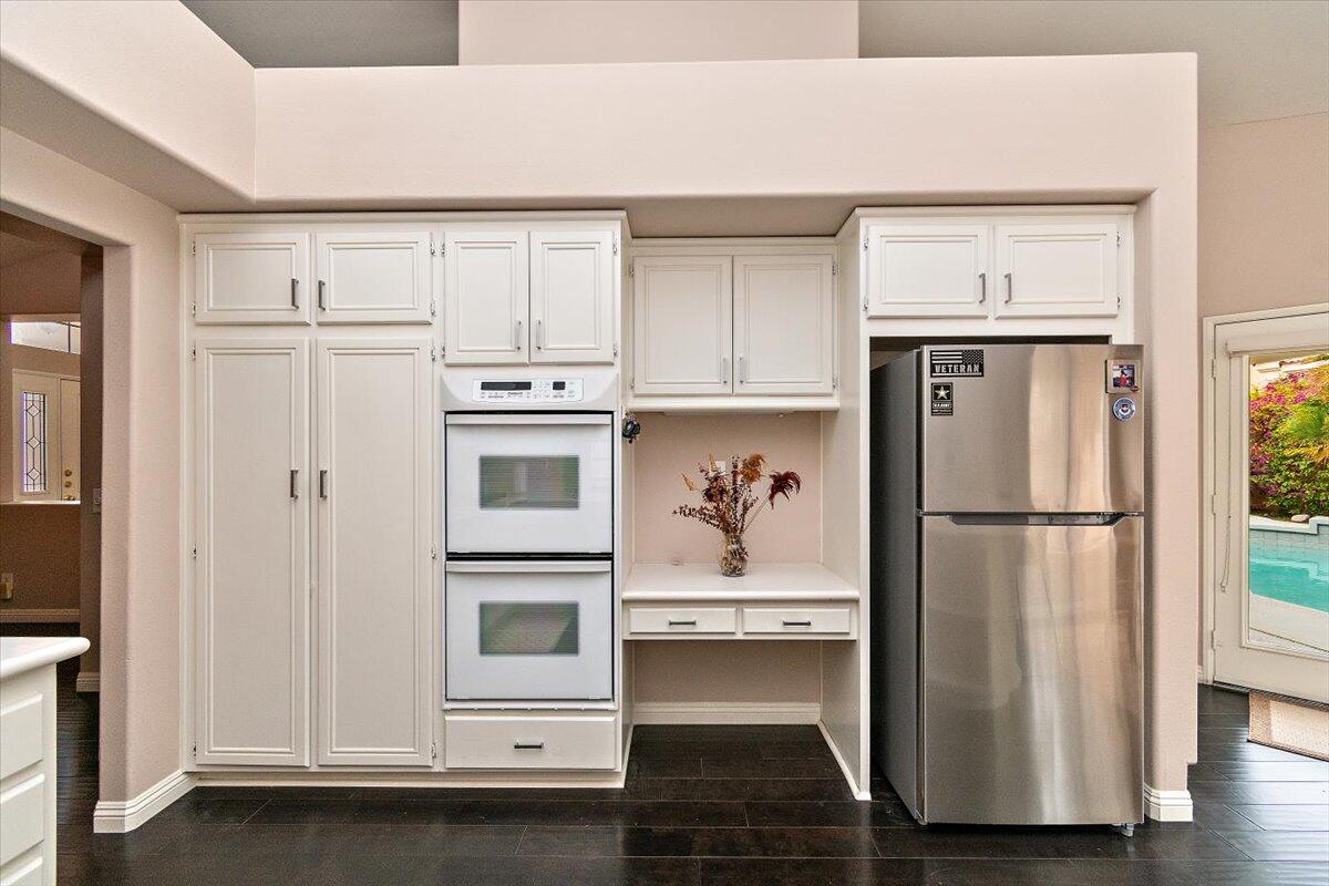 45510 Desert Fox Drive La Quinta, CA 92253 - Photo 24 of 49 a kitchen with cabinets and stainless steel appliances